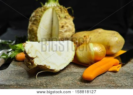 Ingredients for celeriac soup - celery root - celeriac carrots onion potatoes - healthy diet concept