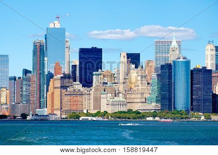 The Lower Manhattan skyline iand Battery Park n New York City seen from the ocean on a sunny summer day