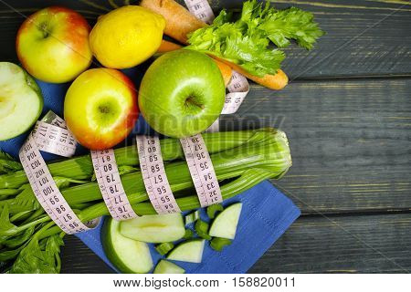 Green vegetables and fruits - celery shoots and apples healthy fitness diet concept