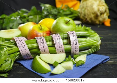 Green vegetables and fruits - celery shoots and apples healthy fitness diet concept