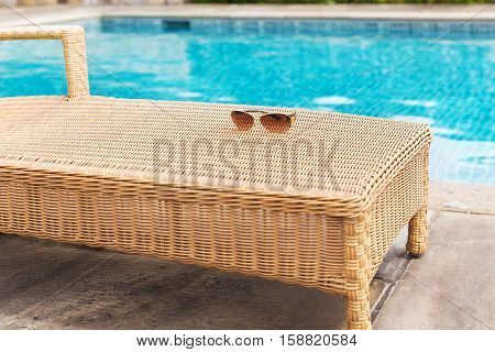 Sunglasses and colorul swimwear near swimming pool
