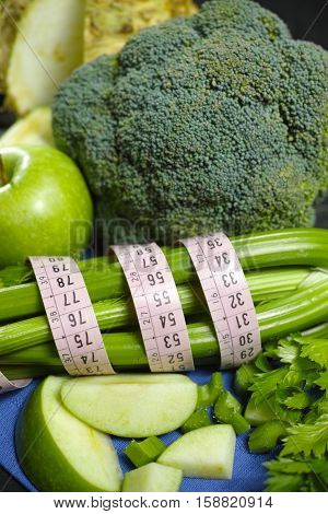 Green vegetables and fruits - celeriac broccoli celery shoots and apples healthy fitness diet concept