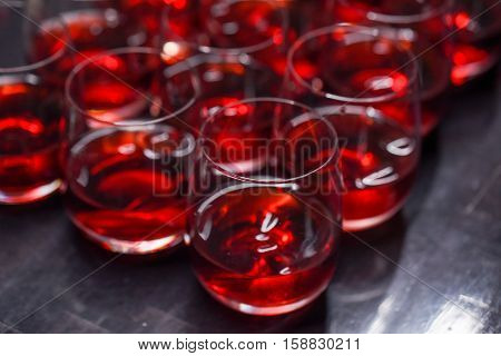 Many alcoholic cocktail drinks with crainberry or strawberry on pub bar