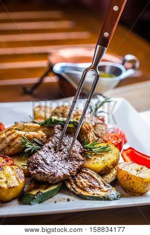 Beef Steak. Sirloin steak. Delicious juicy beef steak on fork. grill vegetables.