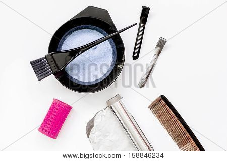 Tools for hair dye and hairdye top view on white background