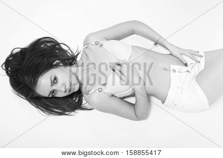 sensual girl in lingerie lying on white, monochrome image