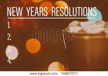 New Years Resolution List against hot chocolate cup