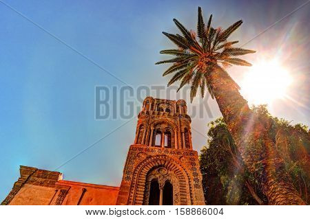 Belltower of church Martorana with palm trees, Palermo. Sicily. Beautiful architecture of the historical district.