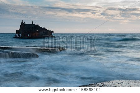 Shipwreck of an abandoned ship on a rocky coast at Akrotiri Beach in Cyprus