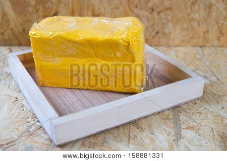 whole block butter on wood tray on wood table