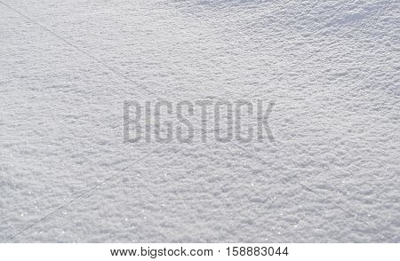 The image of snow. Snowy background. White snow. Winter landscape. The background for the text.