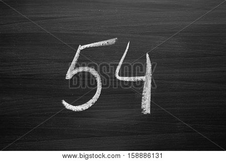 number fifty four enumeration written with a chalk on the blackboard