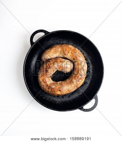 homemade sausages in a pan on a white background