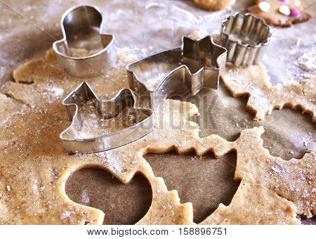 Christmas cookies or christmas baking with cookie dough and christmas ornaments. Cookie cutters.