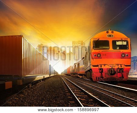 industries container trains and boxcar on track against building in town  for industrial logistic and land transportation