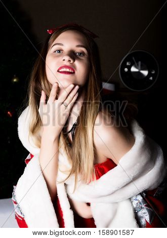 beautiful female nurse sexy woman in carnival costume, on her shoulders a red fur coat.
