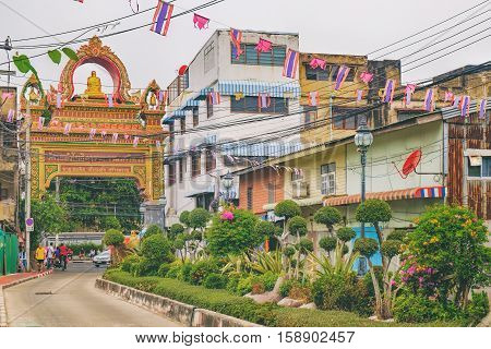Bangkok, Thailand - January 8, 2016: Trok Watrakhang Alley is the main entrance to Wat Rakhang Kho Si Ta Ram - famous Buddhist Temple in the center of Bangkok.