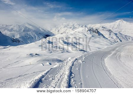 Alpine winter mountain landscape. French Alps covered with snow in sunny day. Val-d'Isere, France