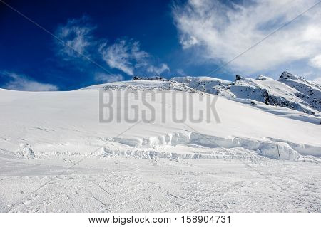Alpine winter mountain landscape. French Alps covered with snow in sunny day. Val-d'Isere, France