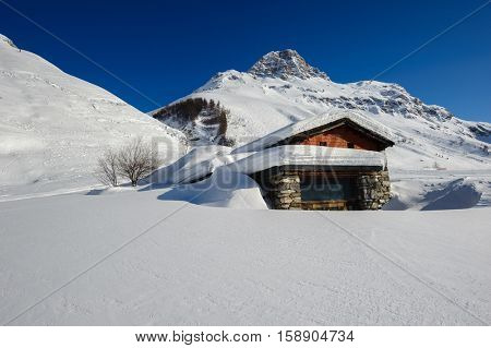 Alpine winter mountain landscape. French Alps covered with snow in sunny day. Val-d'Isere, France