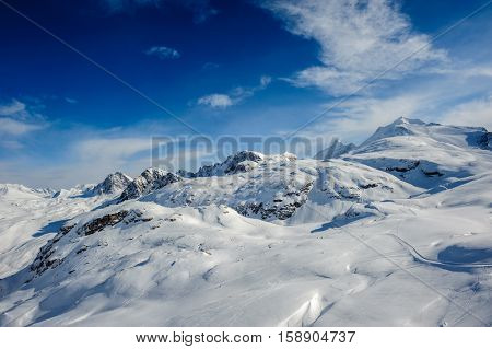 Alpine winter mountain landscape. French Alps covered with snow in sunny day. Val-d'Isere, France