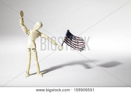 Annonymous average patriotic American represented by an faceless mannequin doll waving a USA flag. Connotations of citizenship and immigration.