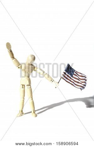 Anonymous American citizen waving a USA flag Represented by a faceless artist mannequin doll. Connotations of citizenship and illegal immigration etc. Shot against a white background with shadow and provinding text space.