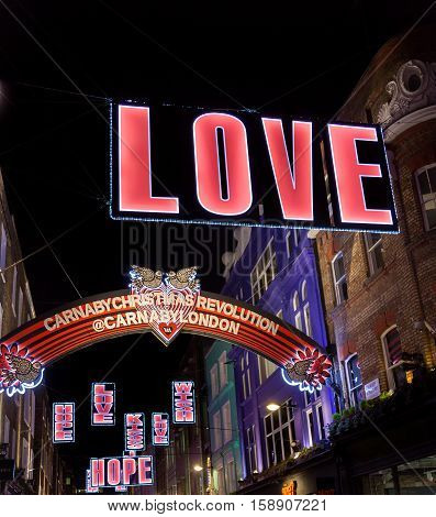 London, UK - November 27, 2016: Christmas fluorescent decorations in fashionable Carnaby Street in London's West End.