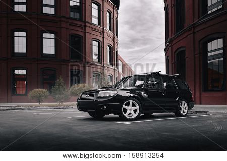 Moscow, Russia - September 25, 2016: Black Car Subaru Forester Parked Near Modern Red Buildings In M