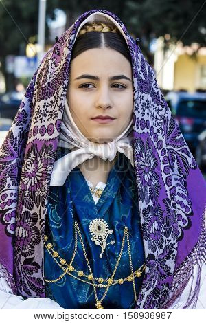 QUARTU S.E., ITALY - September 17, 2016: Parade of Sardinian costumes and floats for the grape festival in honor of the celebration of St. Helena. - Sardinia - portrait of a beautiful girl in traditional Sardinian costume