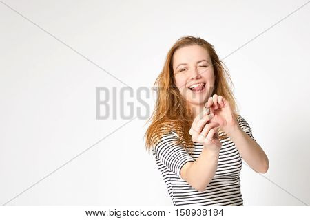Portrait Of A Beautiful Charming Girl Who Plays And Fooling Around, Holding A Hair Elastic