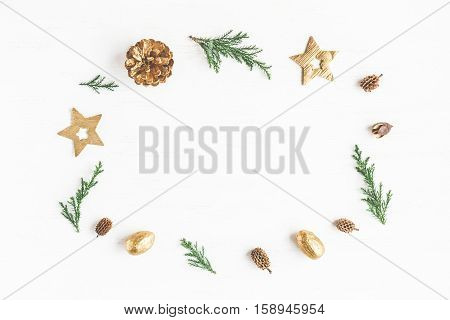 Christmas composition. Frame made of christmas decoration cypress branches pine cones. Flat lay top view
