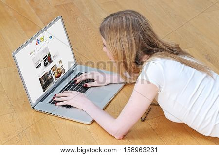London UK - February 06 2015: Young girl looking for bargains online on Ebay shopping site. Ebay is s multinational e-commerce company providing consumer-to-consumer services via the Internet.