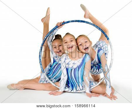 Little beautiful gymnasts with the hoop on white.