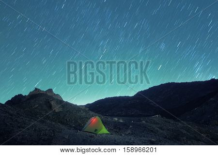 stars trails on lighting tent in Etna Park lunar landscape, Sicily  