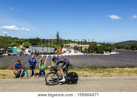 Les ArredonsFrance - July 152016: The British cyclist Luke Rowe of Team Sky riding during an individual time trial stage near a field of lavanda in Ardeche Gorges during Tour de France 2016.