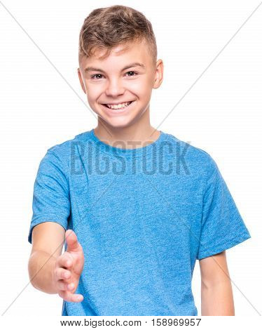 Half-length emotional portrait of caucasian teen boy wearing blue t-shirt, handshake gesturing. Funny teenager with open hand ready for handshake, isolated on white background. Handsome happy child putting out his hand for shaking.