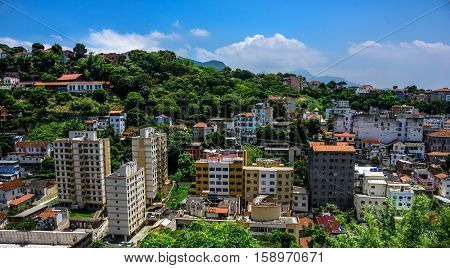 Beautiful view of typical residential houses in the neighborhood of Santa Teresa and blue sky at hot, sunny day in Rio de Janeiro, Brazil
