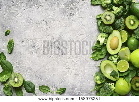 Variety Of Green Fruits And Vegetables On A Concrete Or Stone Background.top View.