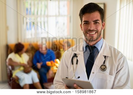 Portrait of young doctor at work as physician in hospital for seniors. Man working in hospice with elderly people health care professional