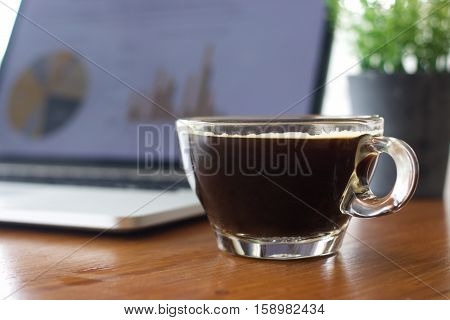 Laptop and coffee cup on old wooden table