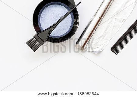 Tools for hair dye and hairdye top view on white background