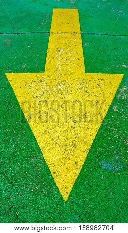 Big yellow arrow on the green background pointing down