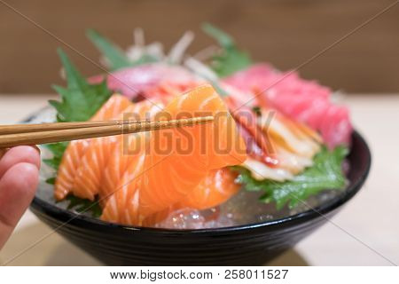 Mixed Sliced Fish Sashimi On Ice In Black Bowl. Sashimi Salmon Tuna Hamachi Prawn And Surf Calm Set,
