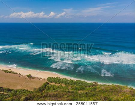Top Aerial View Of Beauty Bali Beach. Empty Paradise Beach, Blue Sea Waves In Bali Island, Indonesia