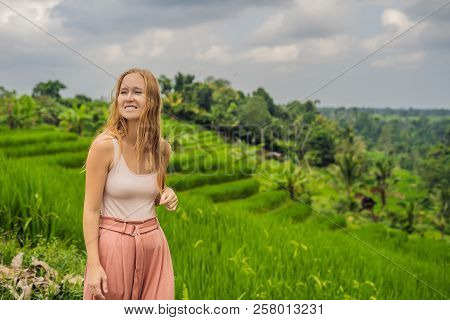 Young Woman Traveler On Beautiful Jatiluwih Rice Terraces Against The Background Of Famous Volcanoes