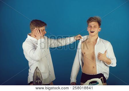 Men Getting Dressed. Happy Brother Wearing Shirt Wrong And Giving Thumbs Up Hand Gesture. Twin Looki