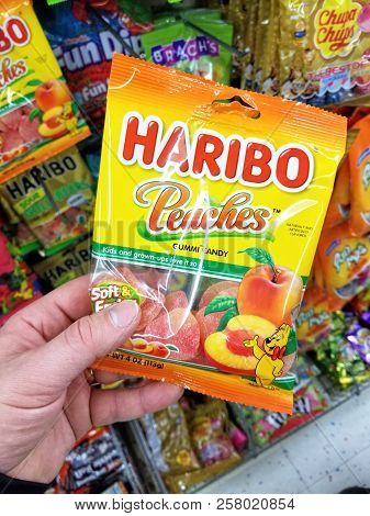 Plattsburgh, Usa - September 10, 2018: A Man Holding Haribo Peaches Pack. Haribo Is A German Confect