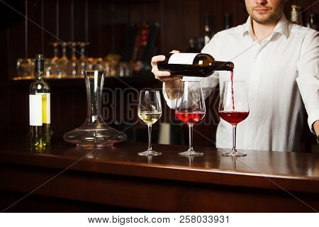 Sommelier Pouring Different Types Of Fine Wine