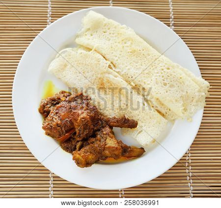 Chita Ruti A Bengali Cuisine With Hot Chicken Curry In A White Plate
